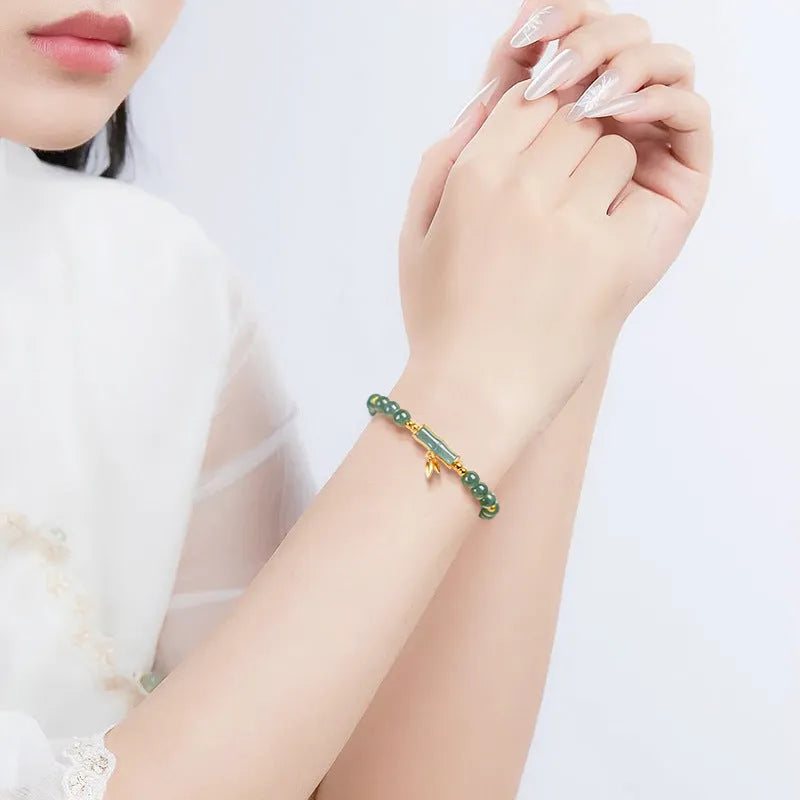 S925 silver bracelet with natural A cargo jade and blue round beads on a wrist.