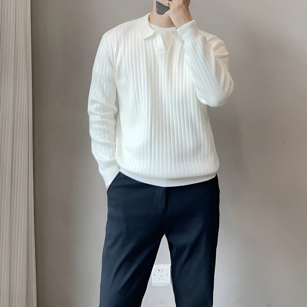 Man wearing a loose grey striped knit sweater with a lapel, long sleeves, and textured fabric.