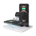 Black wireless charging station for phone watch headphones on desktop with USB cable