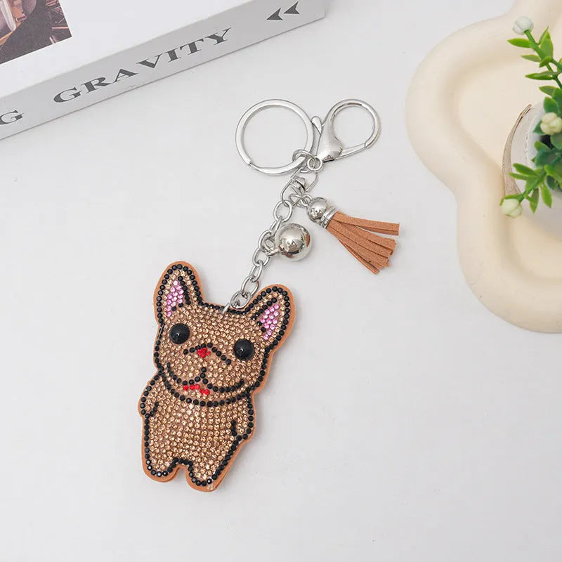 Cartoon dog alloy keychain pendant with rhinestones and bag tassel in caramel colour.