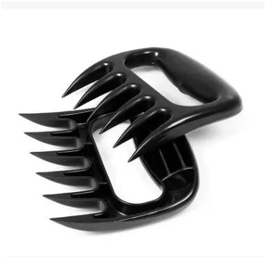 Two black bear claw meat shredder forks with paw patterns for barbecue meat preparation
