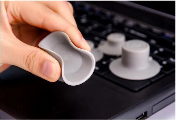 Four grey plastic non-slip cooling pads for laptops, shown in two different sizes.