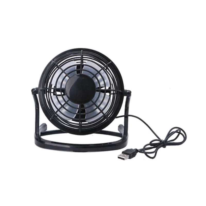 Mini USB desk fan with adjustable angle in black colour beside laptop