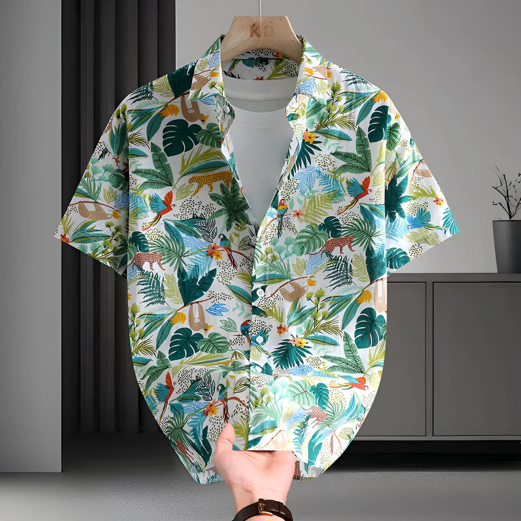 Man wearing a short sleeve Hawaiian style casual shirt with a floral printed pattern.