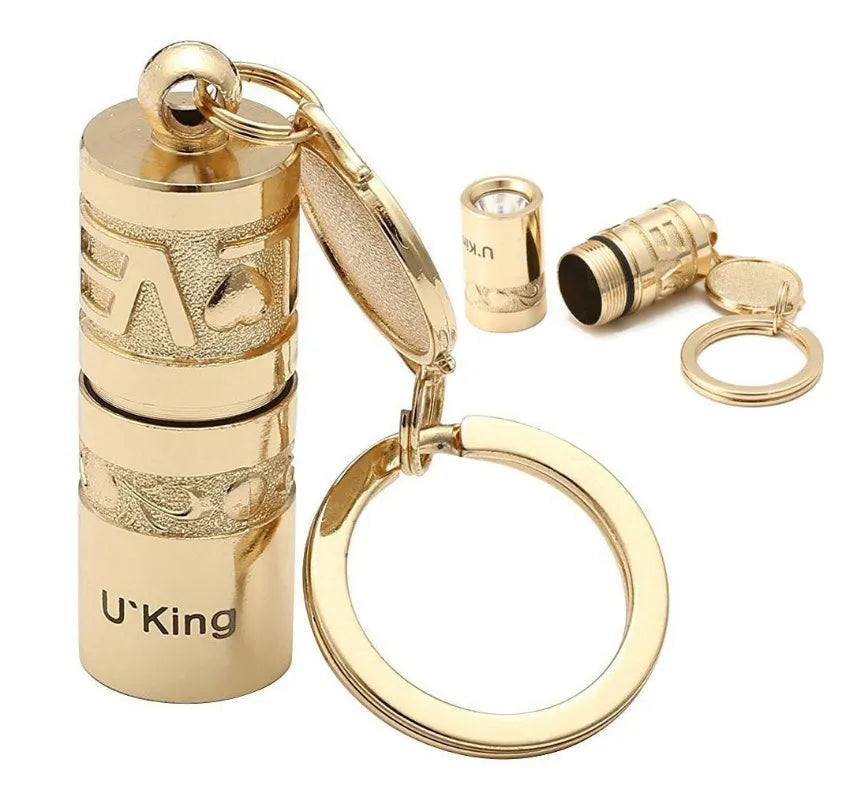 Gold zinc alloy waterproof LED keychain torch for outdoor and emergency use.
