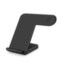 Black and white wireless phone charger with Type-C cable on a desk.