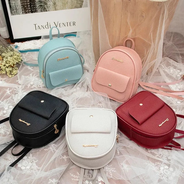 A compact black PU women's backpack purse with a zipper, shown as a small shoulder bag.