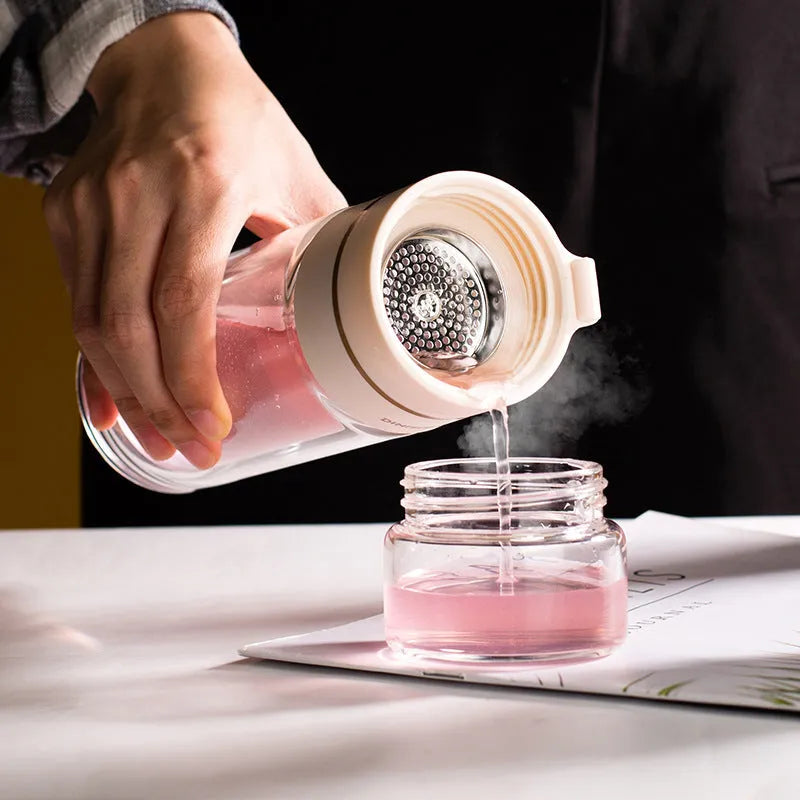 Double wall glass tea infusion bottle with stainless steel filter and rope handle in various colours.