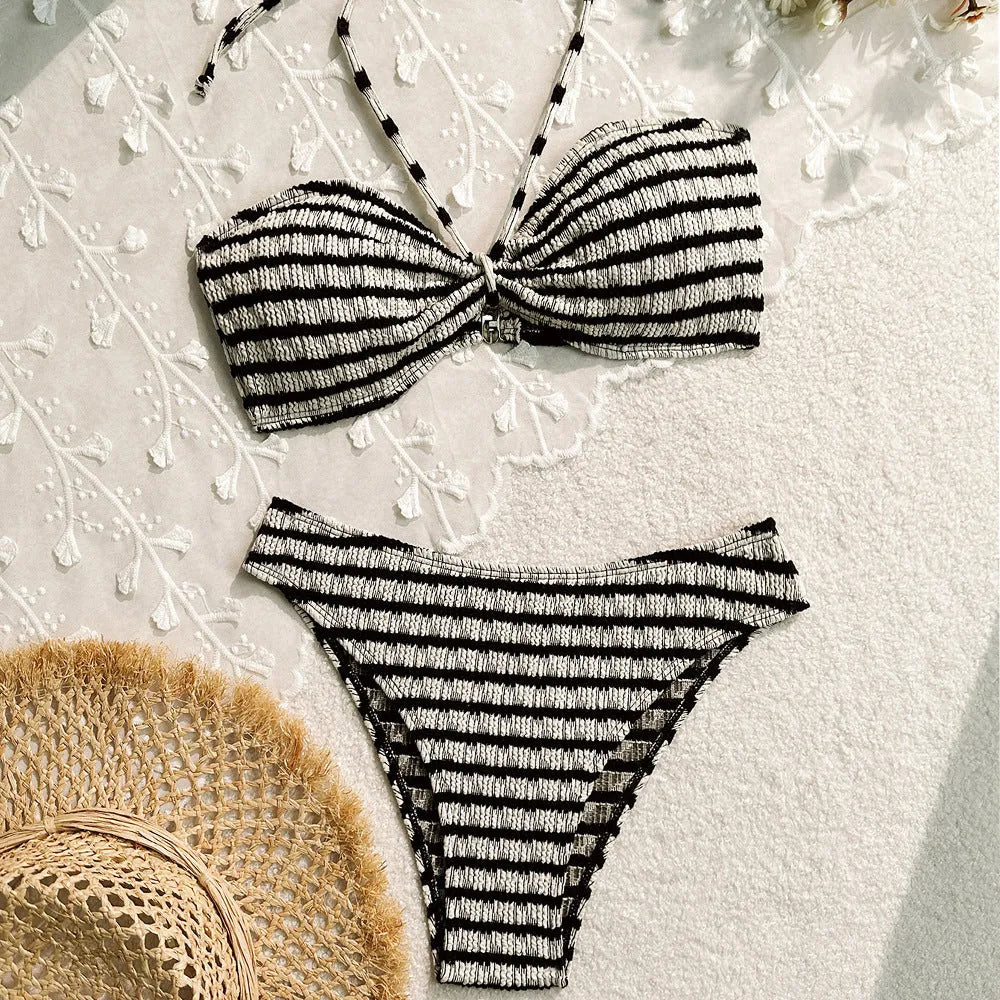 Women's pink and black striped bikini swimsuit with briefs style on a mannequin.