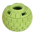 Green and orange natural rubber hollow ball dog toy for slow feeding and chewing.
