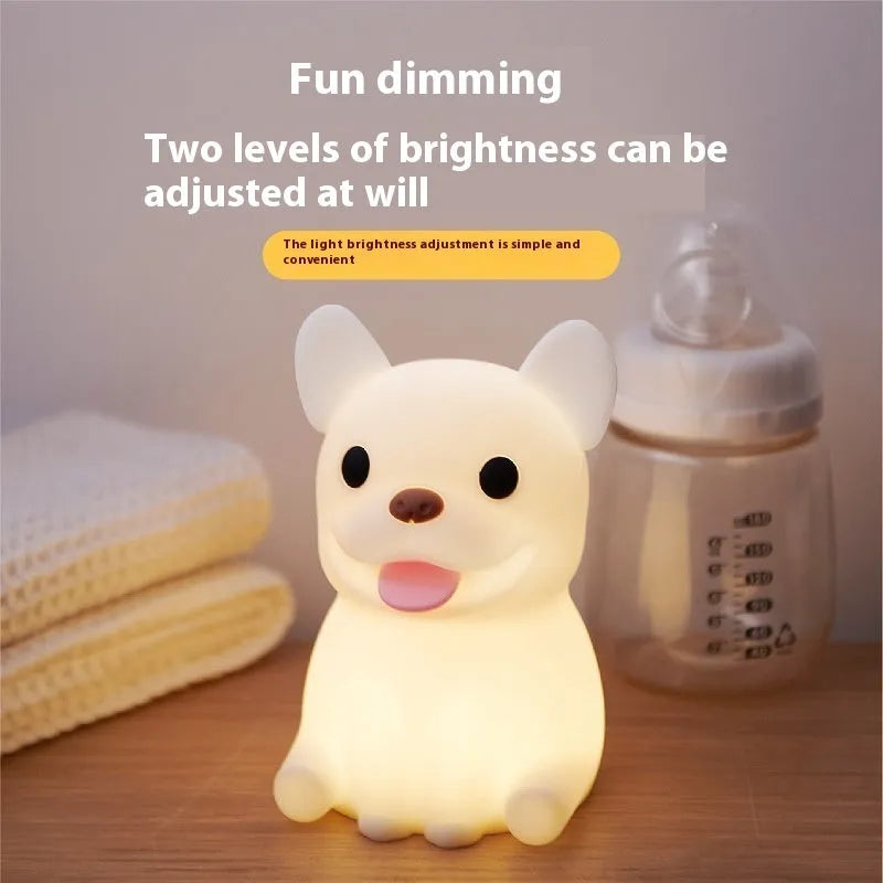 Silicone animal-shaped USB night light with touch dimming on a bedside table.