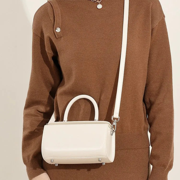 Brown genuine cowhide leather women's crossbody bag with clamshell opening shown open.