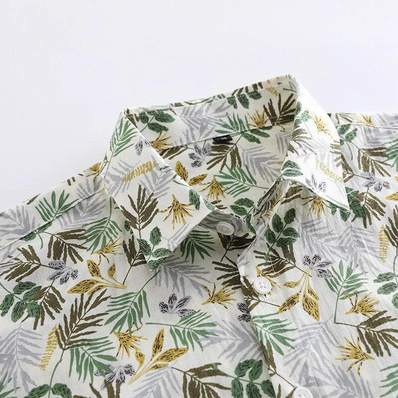 Man wearing a short sleeve Hawaiian style casual shirt with a floral printed pattern.