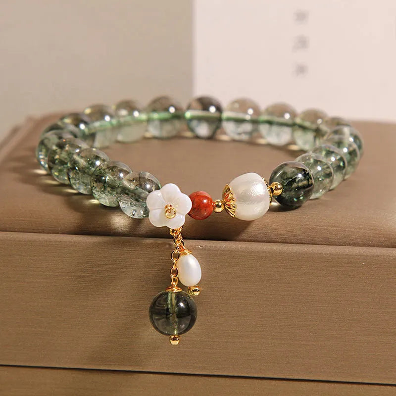 Green phantom quartz crystal bracelet with shell flower and Bells of Ireland design