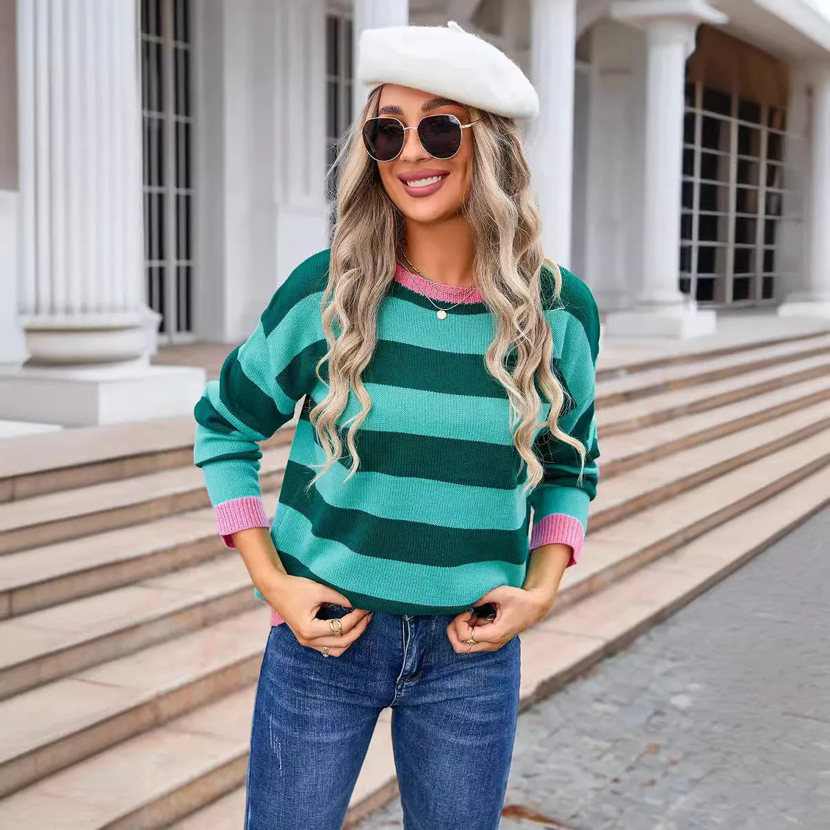 Women's loose blue acrylic sweater with striped pattern and round neck.