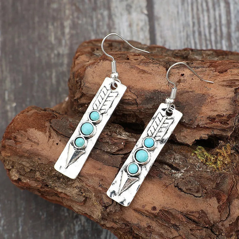 Long geometric silver earrings with turquoise inlay detail, retro style women's jewellery