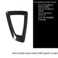 BMW gear base frame in left titanium colour with carbon fibre pattern, showing 3M adhesive backing.