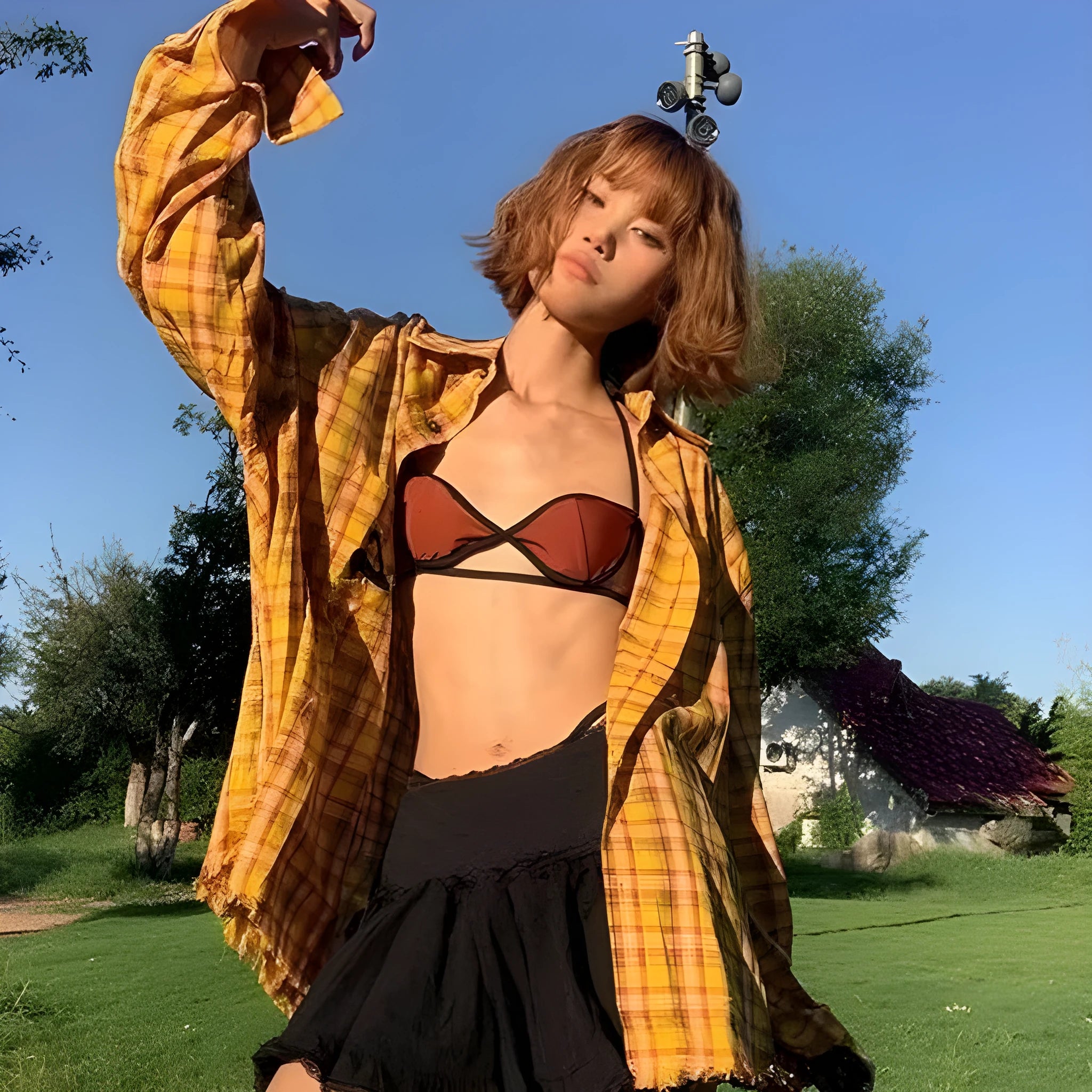 A loose-fitting dopamine yellow plaid shirt with a cardigan style, shown on a hanger.