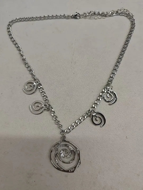 Gold spiral donut jewellery set showing necklace, bracelet and earrings with geometric circle design