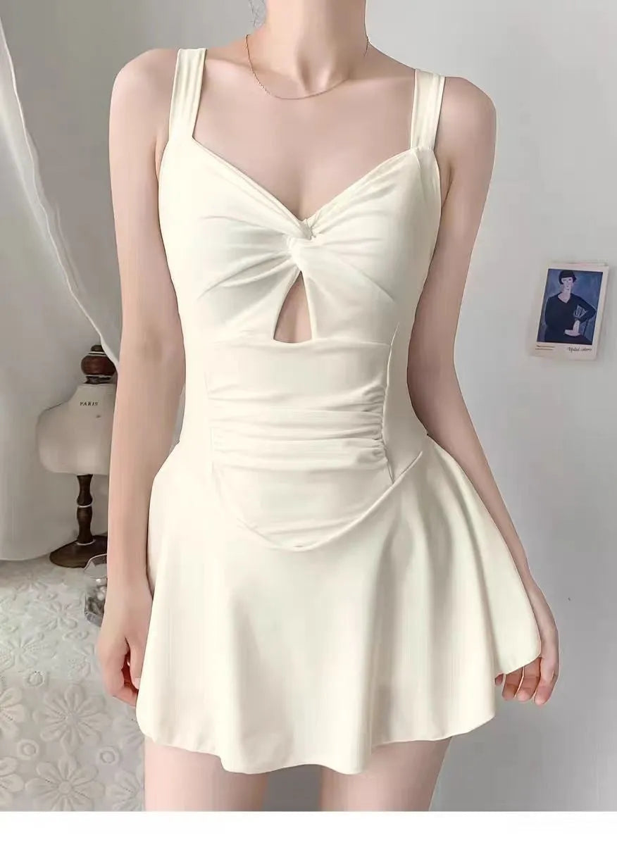 Women's avocado green boxer style one-piece backless swimsuit on a mannequin