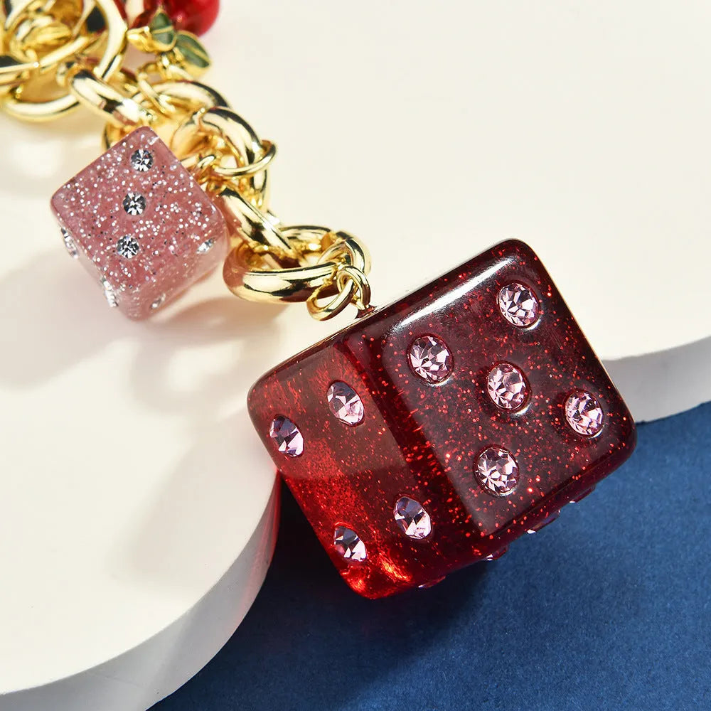 Square metal keychain pendant featuring a vintage cherry red and white two-tone dice pattern.