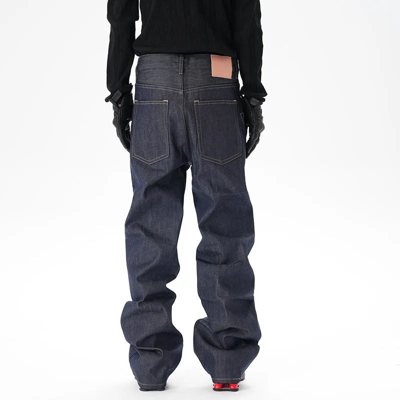 Man wearing dark blue loose straight-leg casual jeans.