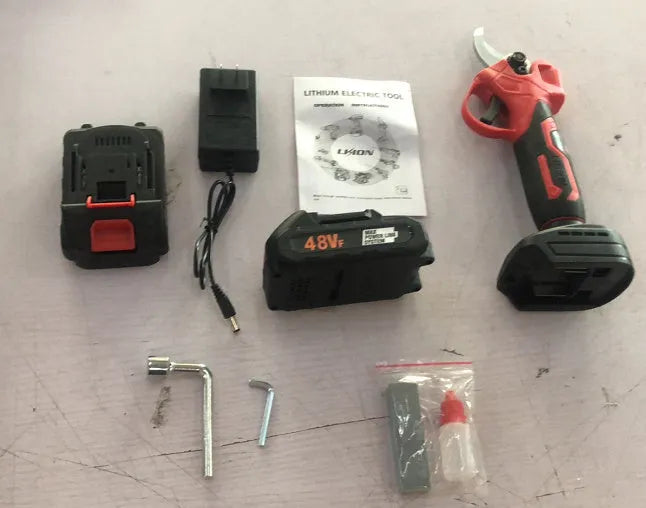 Electric pruning shear with lithium battery in plastic storage box containing two batteries and charger