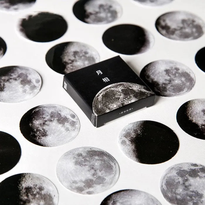 Black moon phase, planet, and calendar design stickers on a sheet, 45 pieces total.
