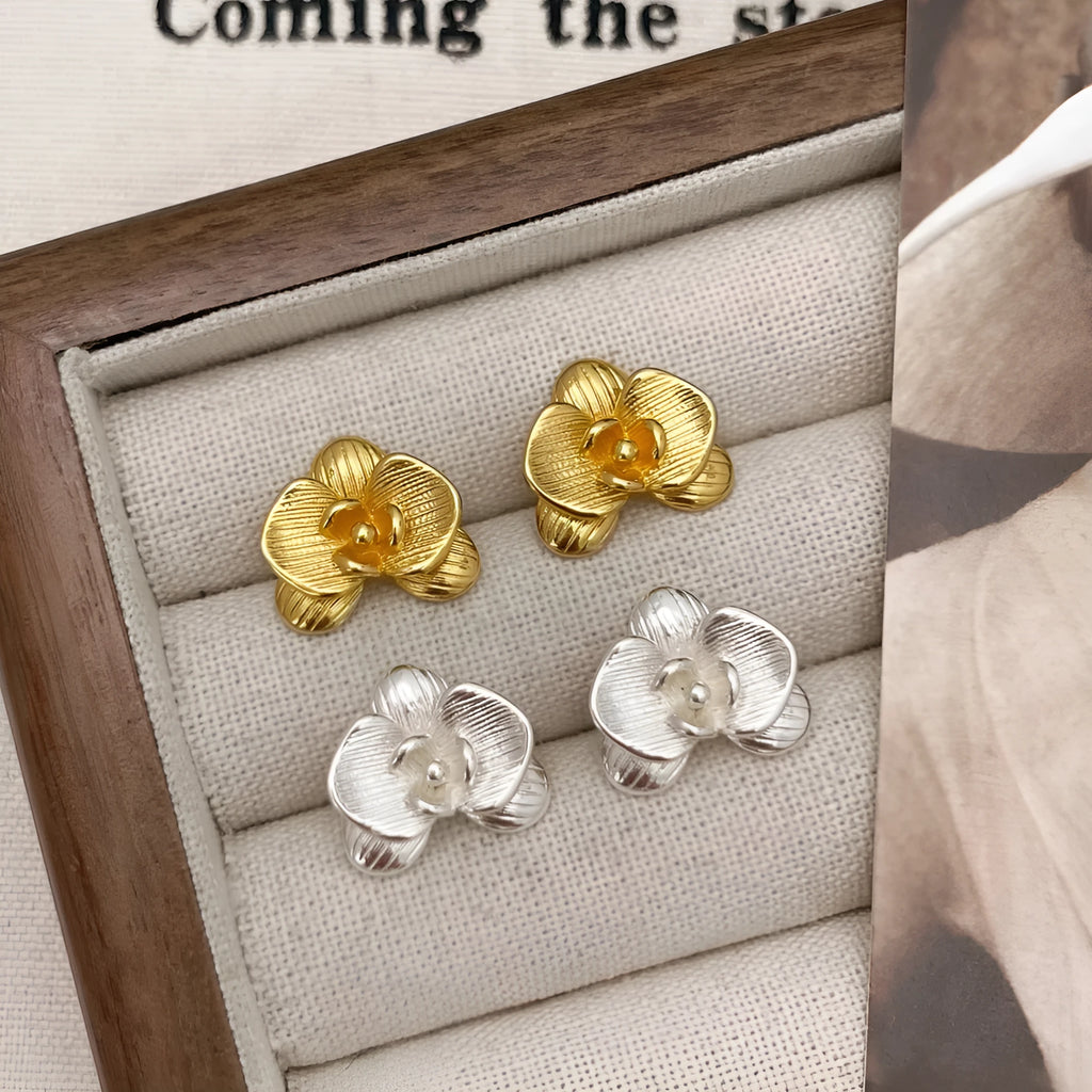 Retro style flower earrings for women in gold or silver finish with petal detailing