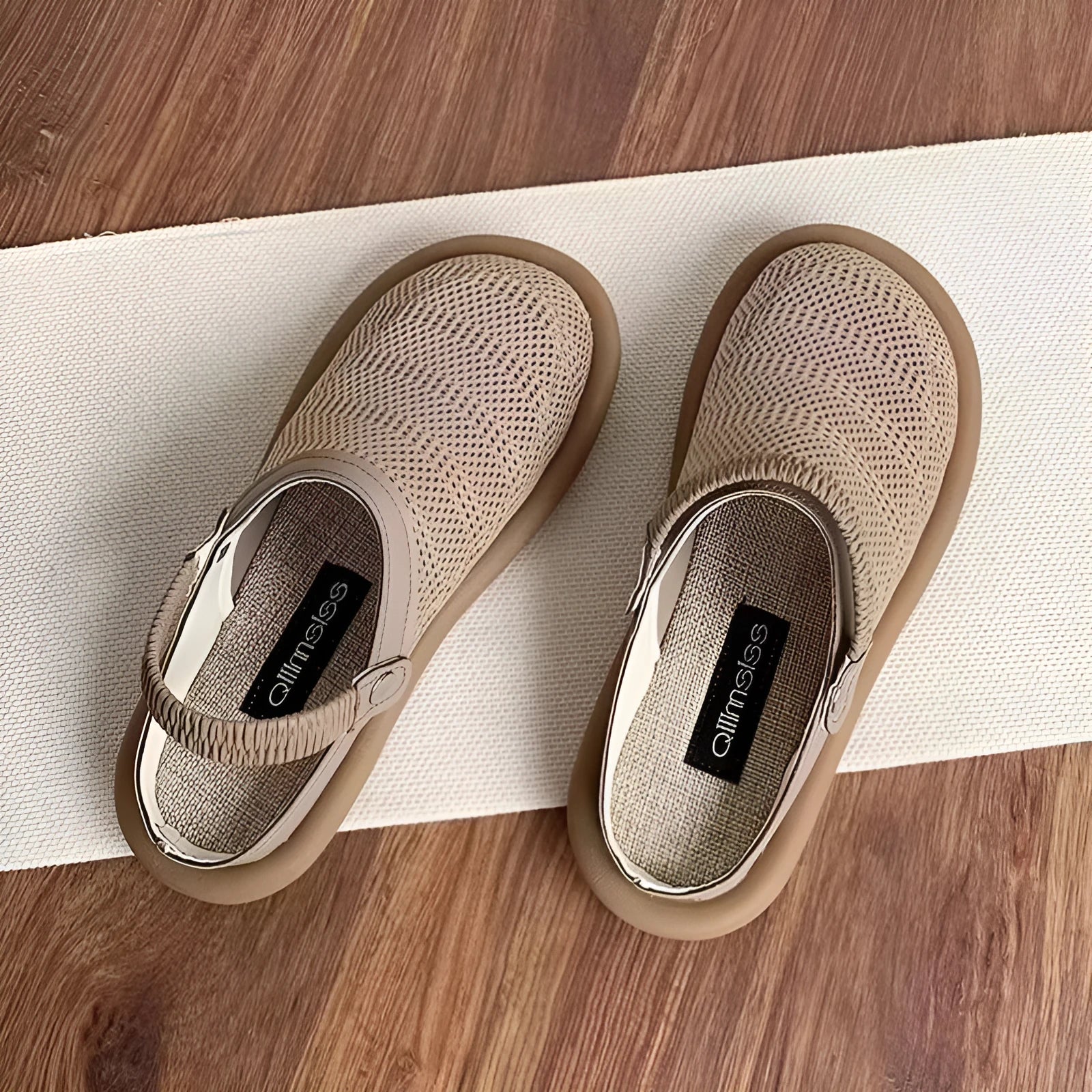 Milky white slip-on shoes with a hollow patterned linen upper and mesh lining, shown on a foot.