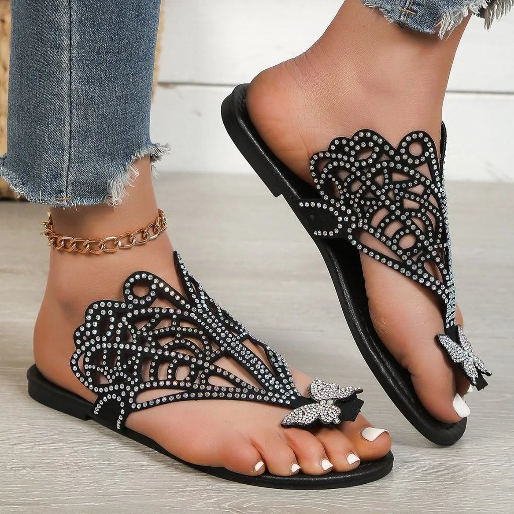 Women's black flip-toe sandals with rhinestone decoration showing slip-on hollow design