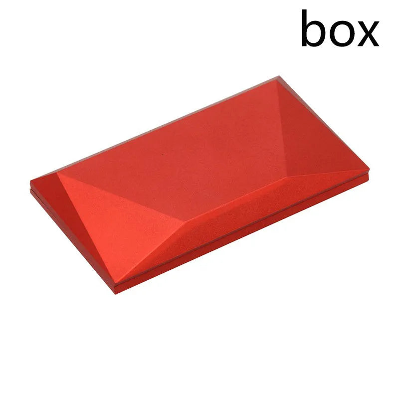 Red heart-shaped plastic ring box on a white background, showing its rotating mechanism.