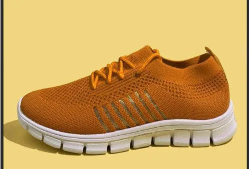 Women's breathable lace-up sneaker in a low-top style with a flat rubber sole.