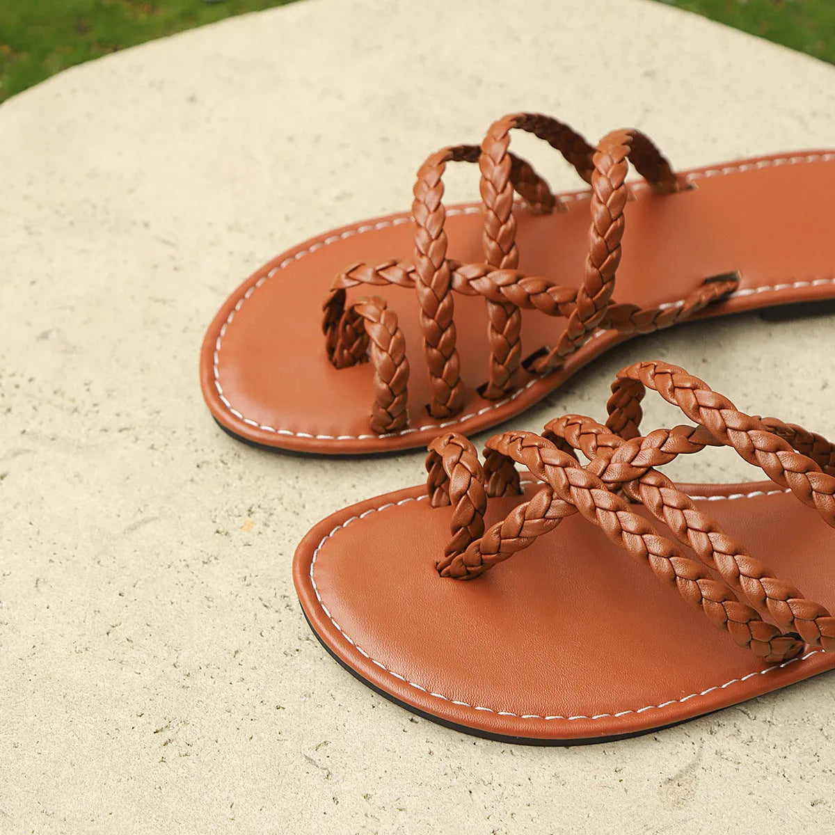 Women's clip-toe woven sandals showing Roman-style design with artificial PU upper and rubber sole