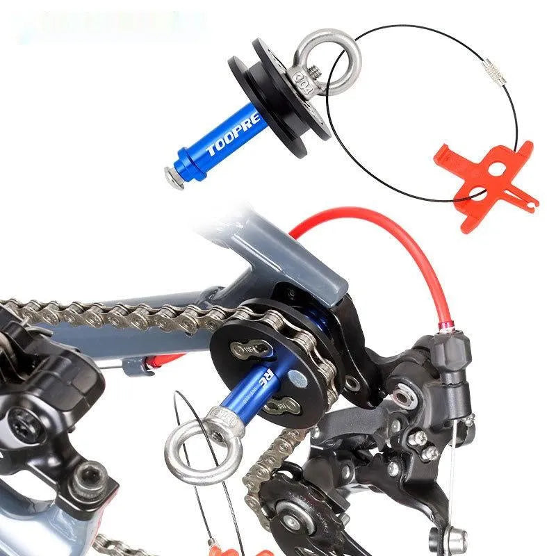 Aluminium bicycle chain holder tool shown in barrel shaft and quick release versions on a workshop bench.