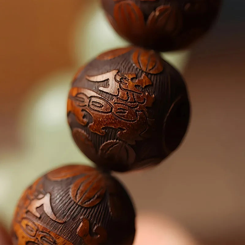 Rosewood bracelet with carved Fu character design showing 20mm beads on wrist
