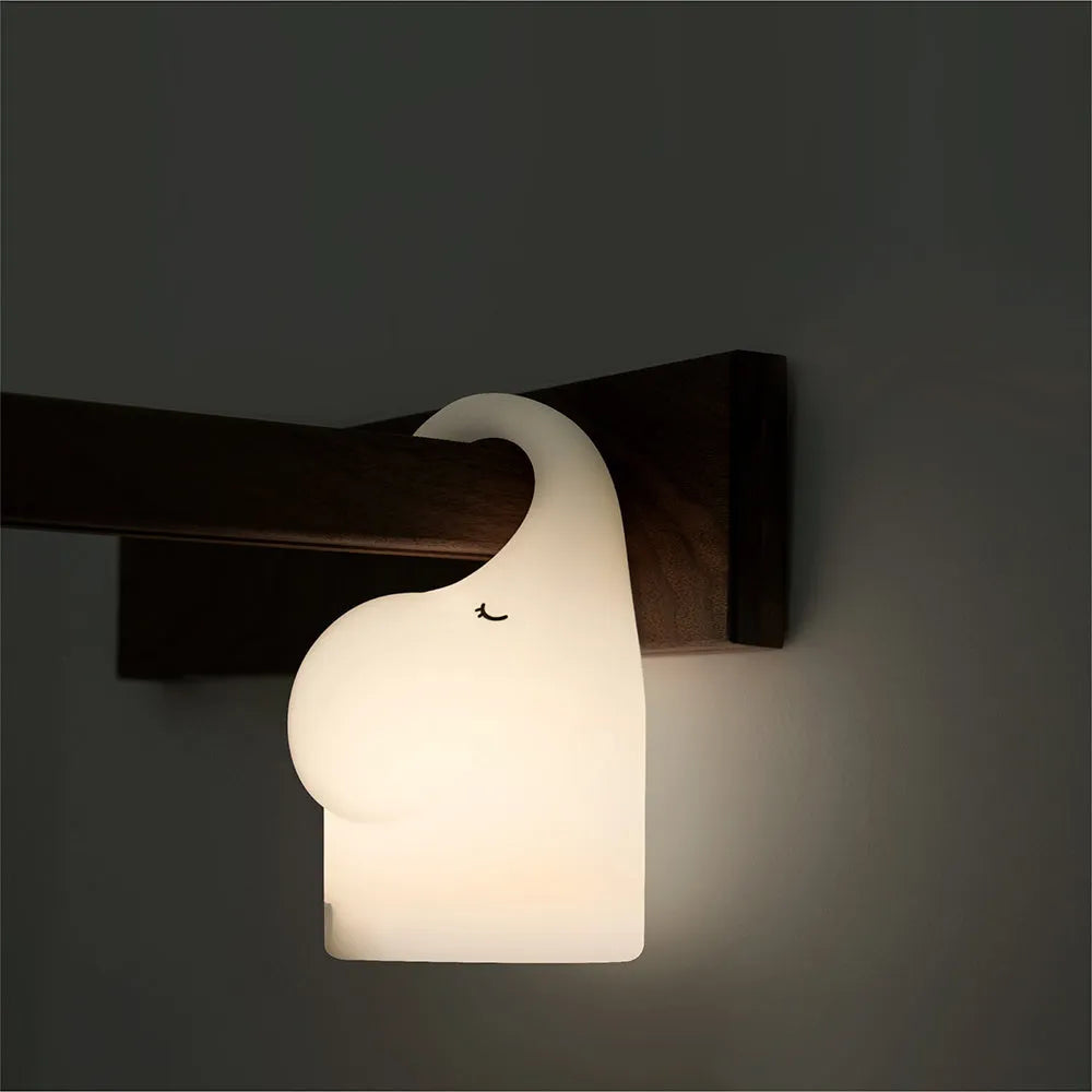 DOMI Elephant-shaped silicone and plastic night light with warm white glow.