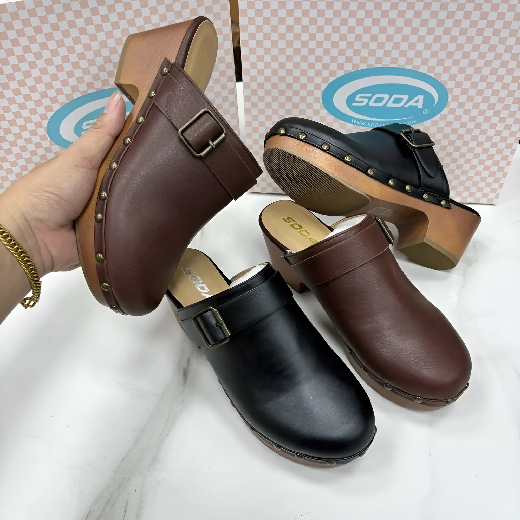 Women's black retro slippers with chunky heel, closed toe, rivet detail on ankle strap, and rubber sole.