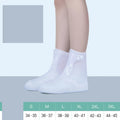 White PVC high-top reusable waterproof shoe cover for women, shown on a foot.