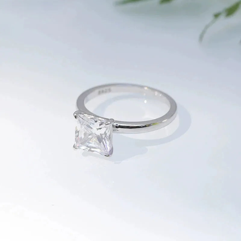Women's simple geometric 925 sterling silver ring in gold, rose gold, or silver colour on a grey background.