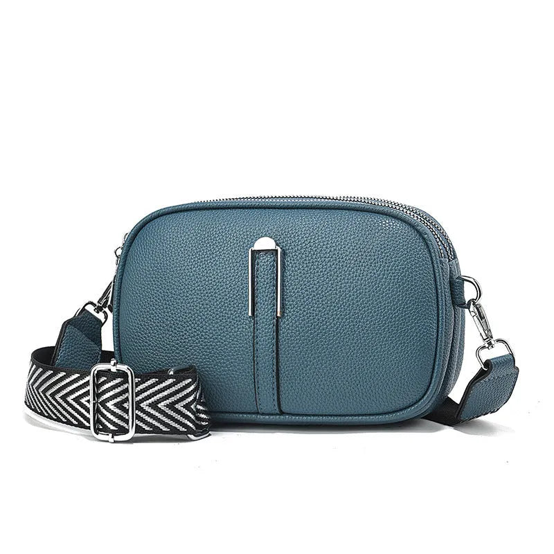 Soft PU leather women's oval crossbody bag showing slit pocket and internal organiser compartments