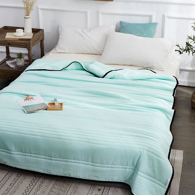 Pure colour seersucker cooling air-conditioning quilt laid flat on a bed