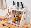 Foldable kitchen storage rack with multi-layer white shelving for organised kitchen supplies
