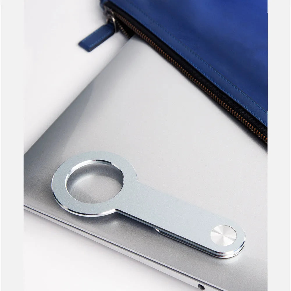 Metallic silver aluminium alloy magnetic phone holder for iPhone on a desk.