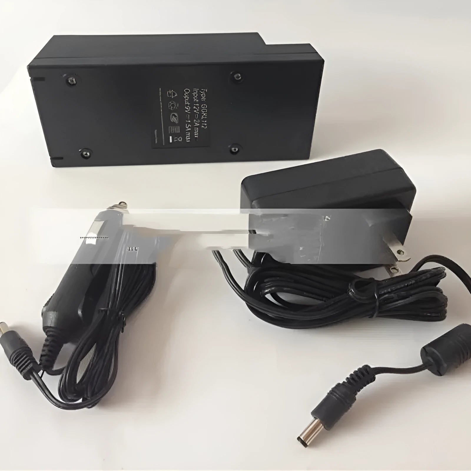 A compact dual USB car charger for 12V and 24V vehicles with a cigarette lighter plug.