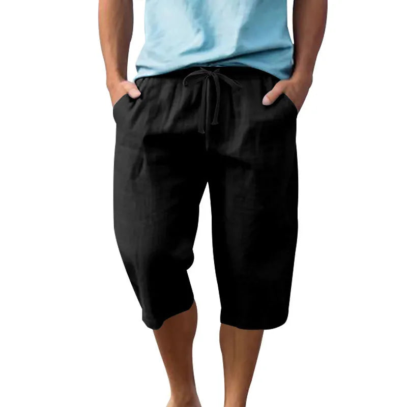 Men's loose fit linen shorts in a solid colour with a high waist and drawstring closure.