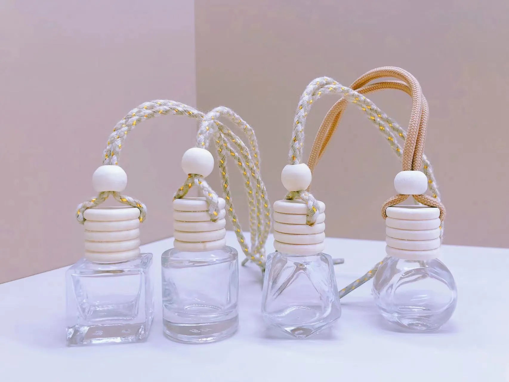 Glass car perfume pendant air freshener in cylinder, diamond, flat drum, and square shapes.