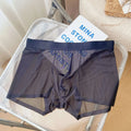 Men's thin grey nylon boxer shorts laid flat, showing seamless mid-waist design.
