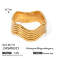 Stainless steel geometric wave ring with wide band design in silver and gold colour options.