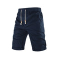 Man wearing grey cotton blend straight leg sports shorts with a drawstring waist and a zipper side pocket.